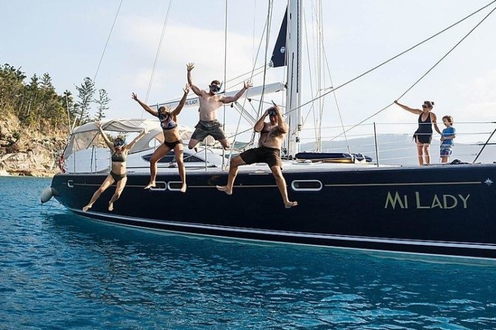a group of people in a boat on a body of water