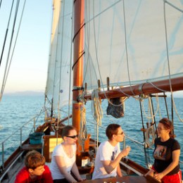 a group of people in a boat on a body of water