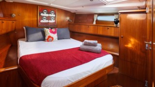 a bedroom with a bed and desk in a room