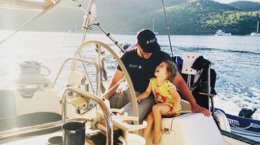 a man sitting on a boat in the water