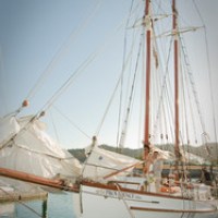 a boat is docked next to a body of water