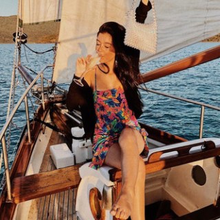 a woman sitting on a boat in the water