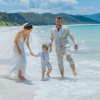 a group of people on a beach near a body of water
