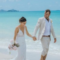 a man and a woman standing next to a body of water