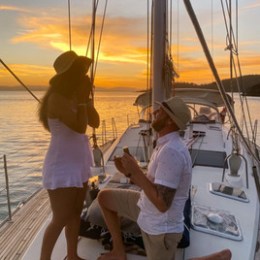 a group of people standing on a boat