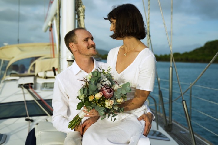 a person sitting in a boat on a body of water