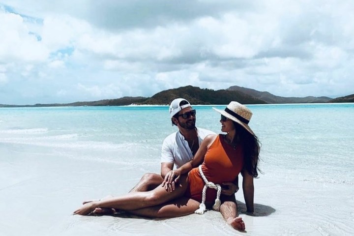 a person sitting next to a body of water