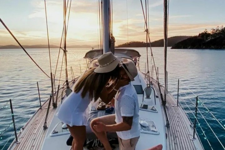 a person sitting on a dock next to a body of water