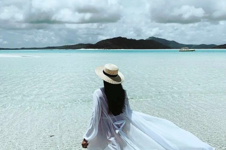 a person standing in front of a body of water