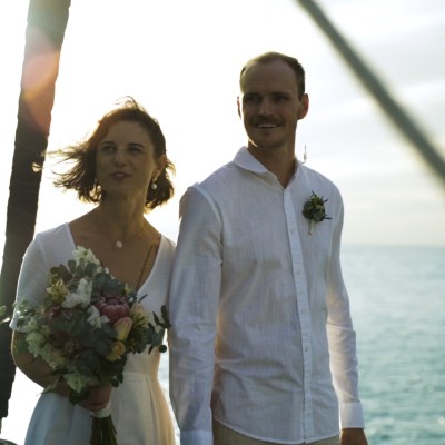 a man and a woman standing in front of water