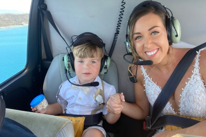 a little girl that is sitting on the seat of a car