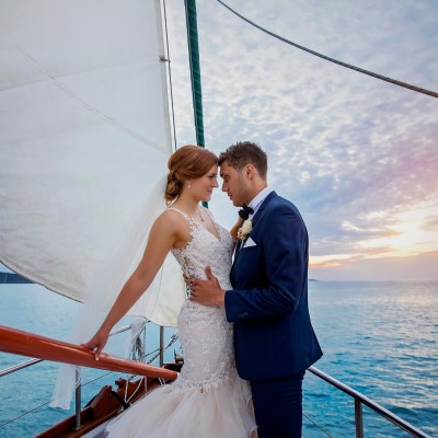 a man and a woman standing next to a body of water